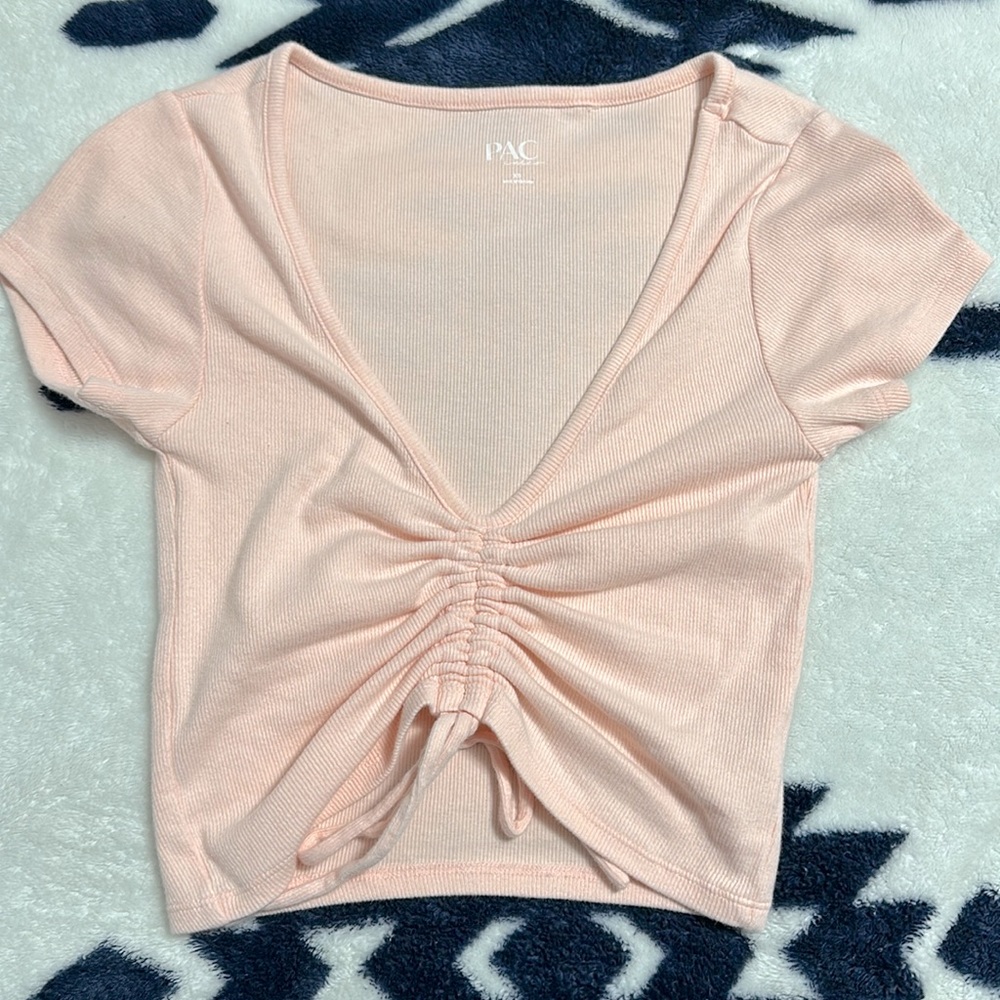 This is a cropped light pink shirt from PacSun!